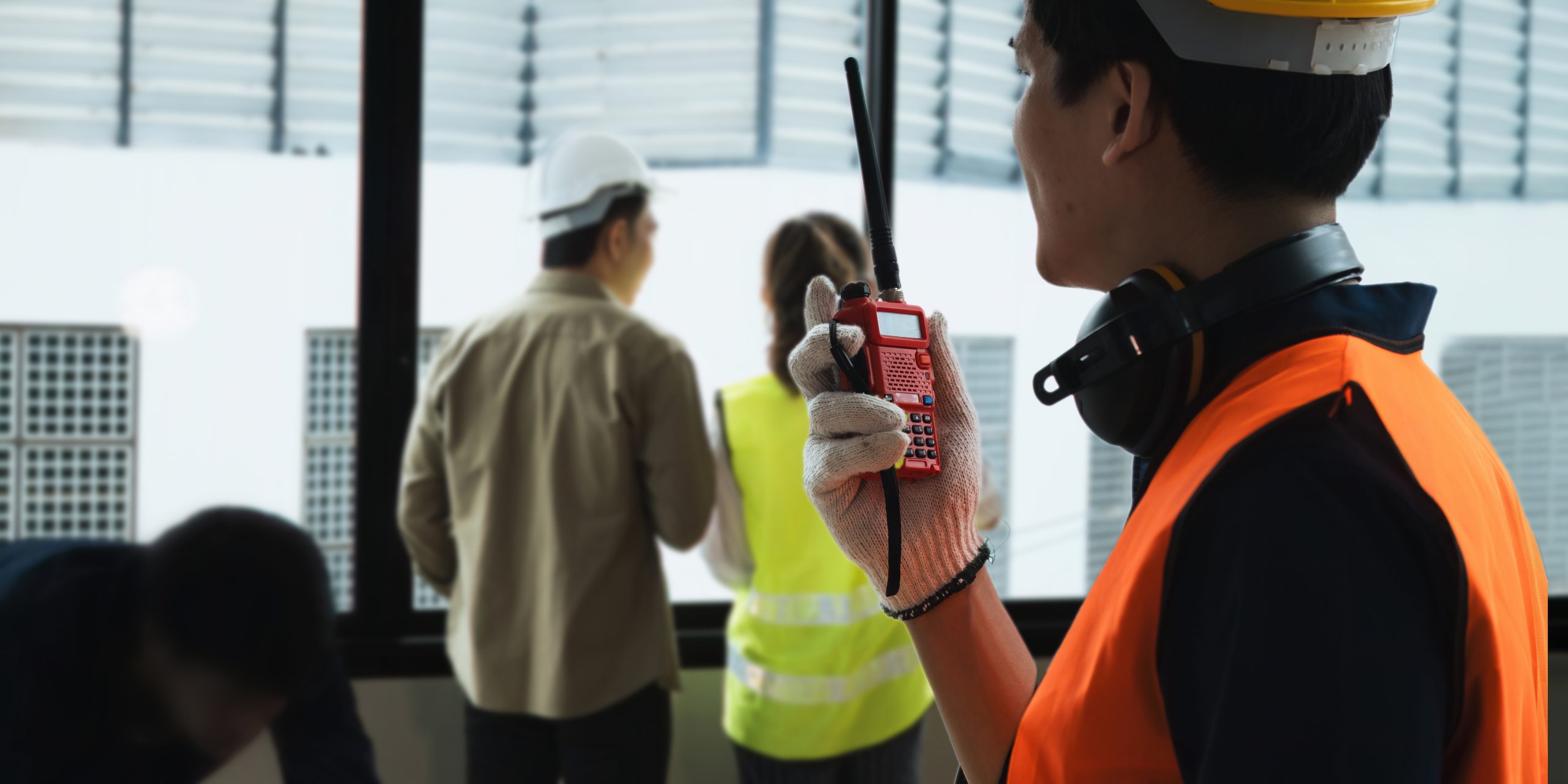 Close up engineer man on a walkie-talkie working of sketching a construction project on his project at office