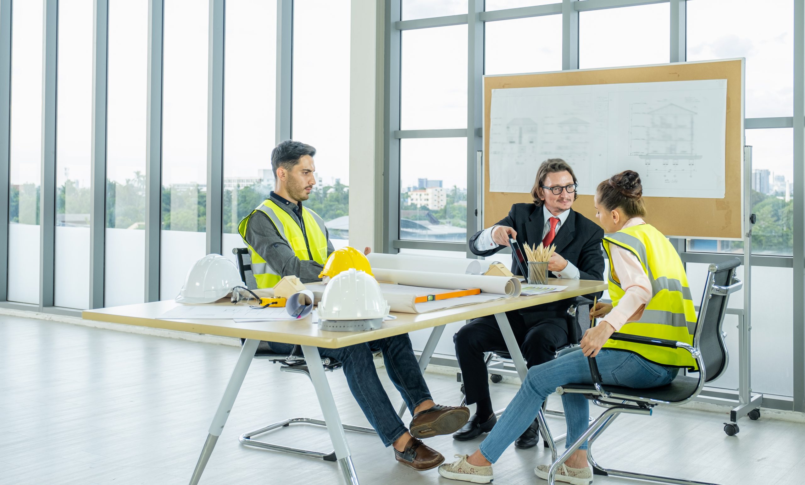 Engineer team is meeting to inspect the construction blueprint d