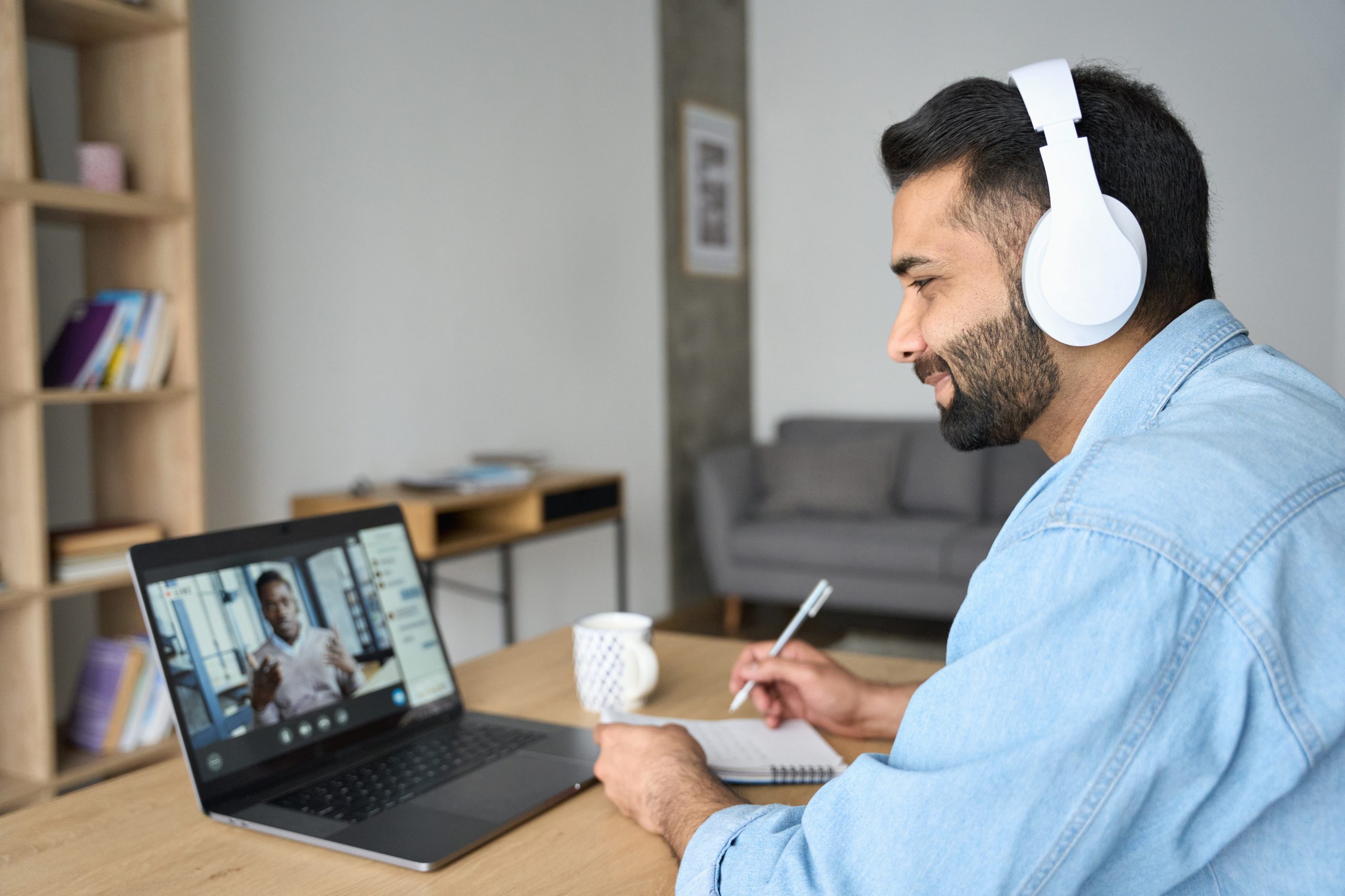 Indian latin male student having video call with male teacher on laptop.